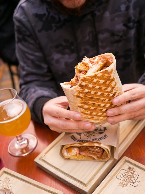 Grilled French Takos held in one hand
